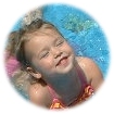 Child in wading pool smiling